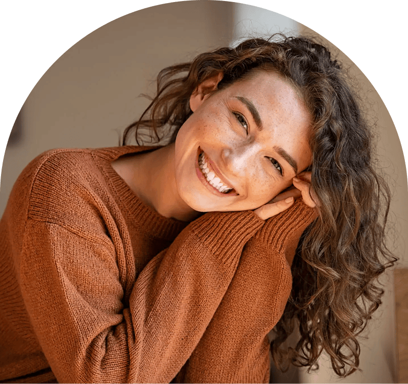 Smiling woman in brown sweater